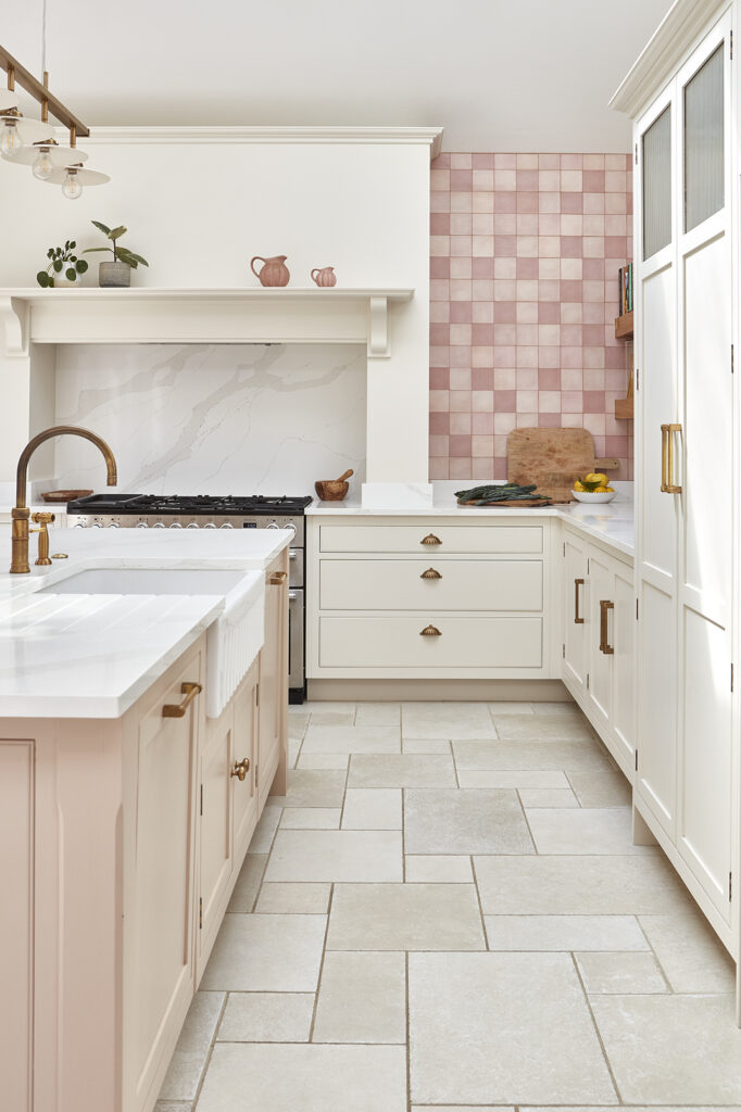 Pink kitchen with neutral cabinetry and large format concrete tile flooring