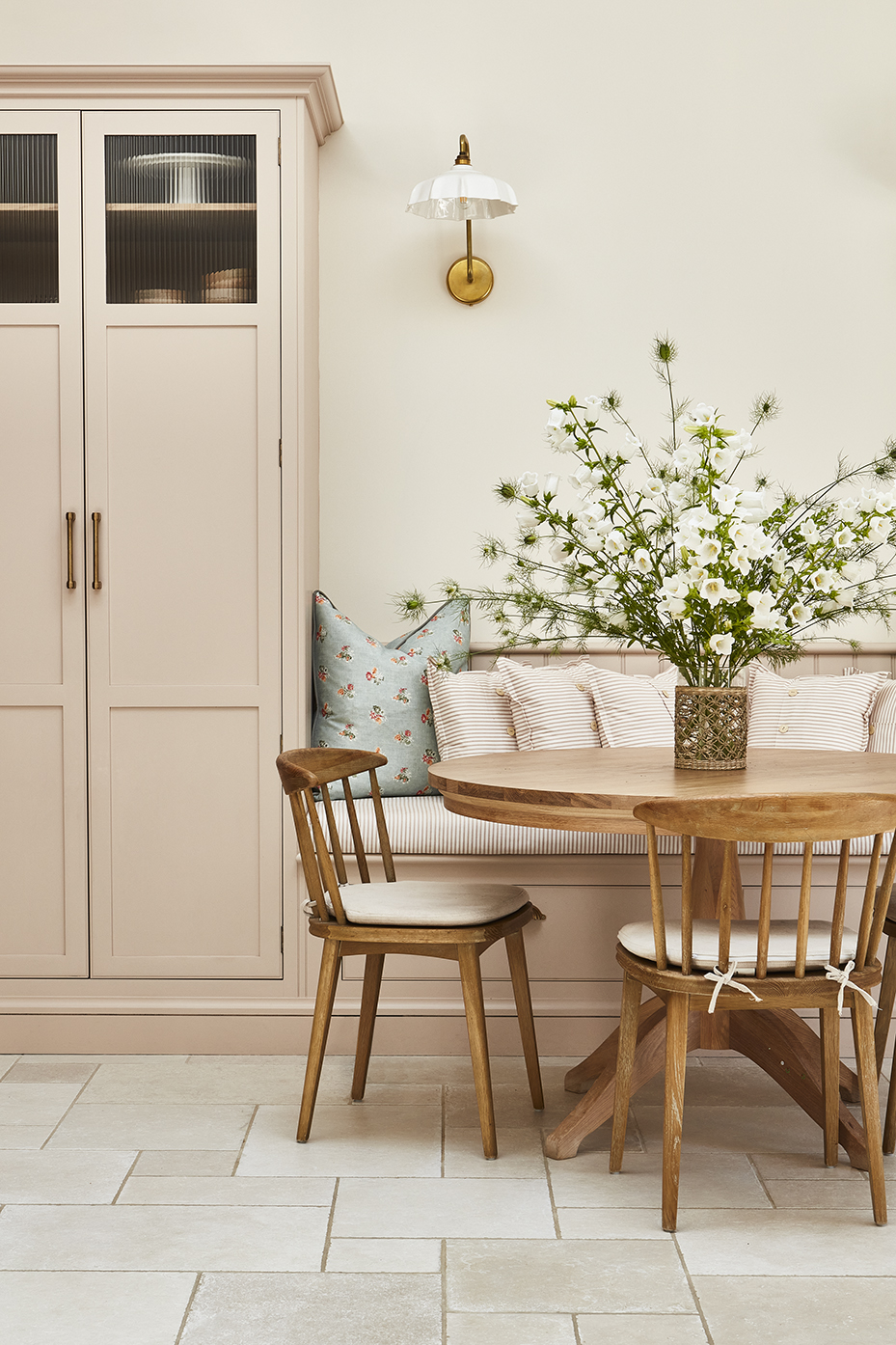 Pink built in breakfast nook in luxury kitchen diner with bespoke pantry cupboards and banquette seating