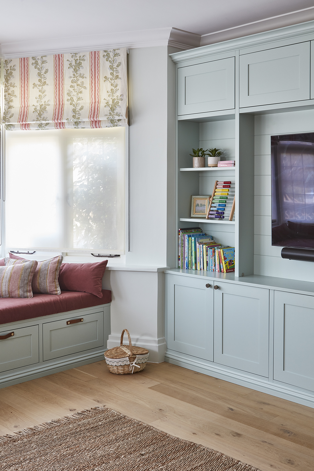 Light blue kids playroom design with bay window reading nook