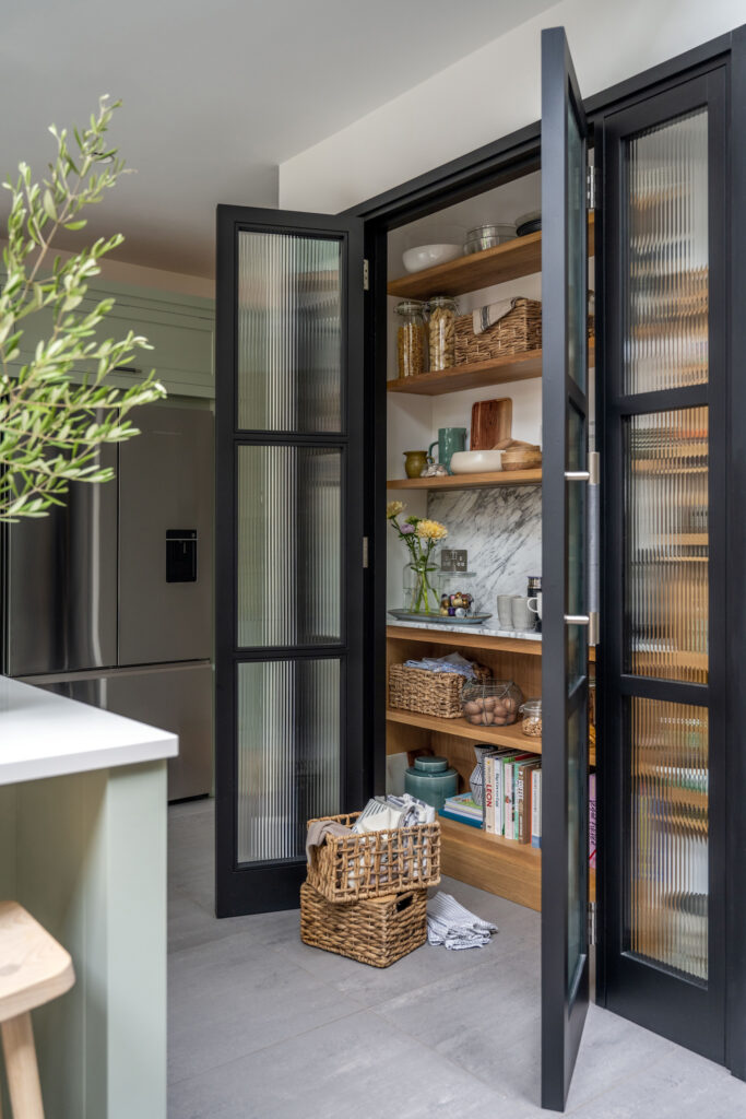 Reeded glass pantry doors in a luxury kitchen design