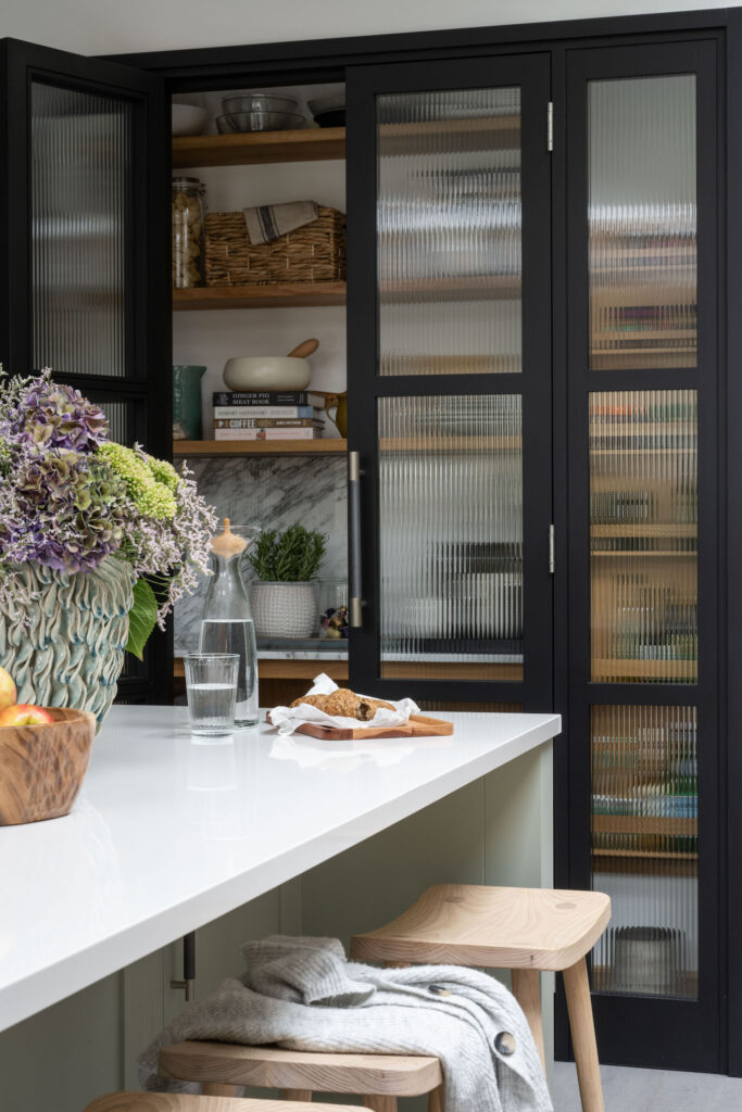 reeded glass fronted kitchen pantry design with black frames