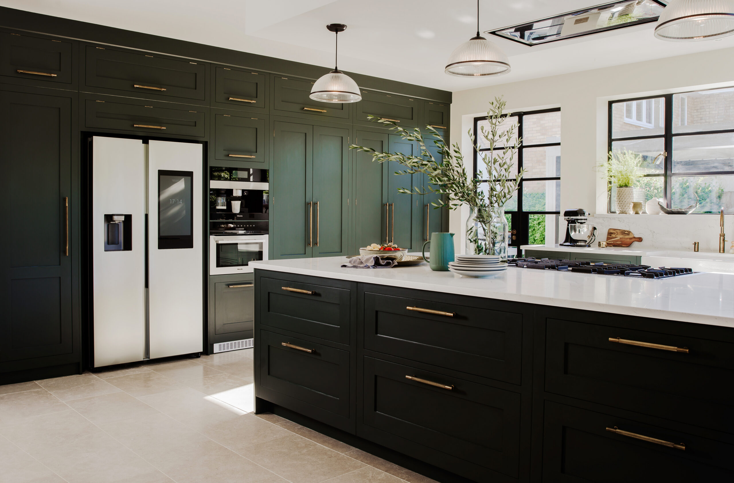 Dark green shaker kitchen with housed appliances and island