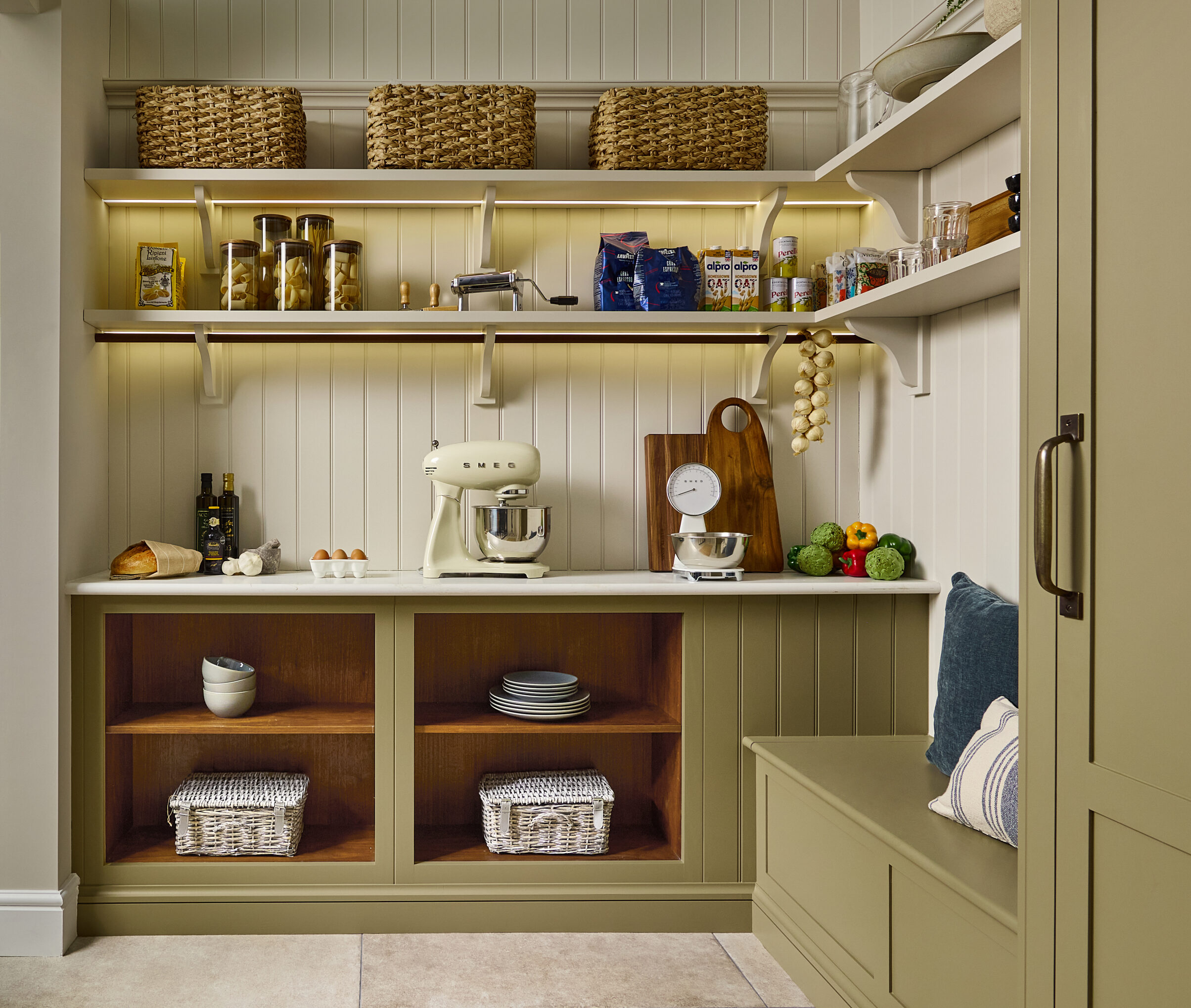 olive green painted walk in pantry with shaker style cabinetry and open shelving