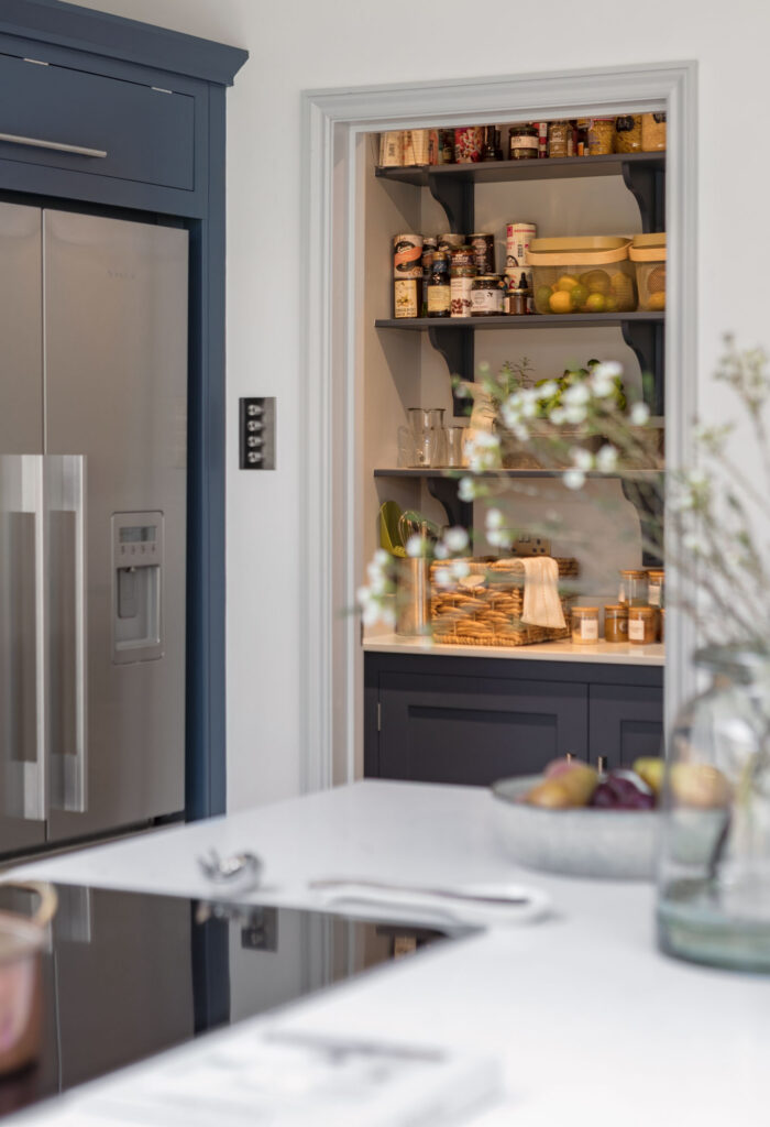 Navy blue and white walk in pantry room with open shelving in bespoke kitchen