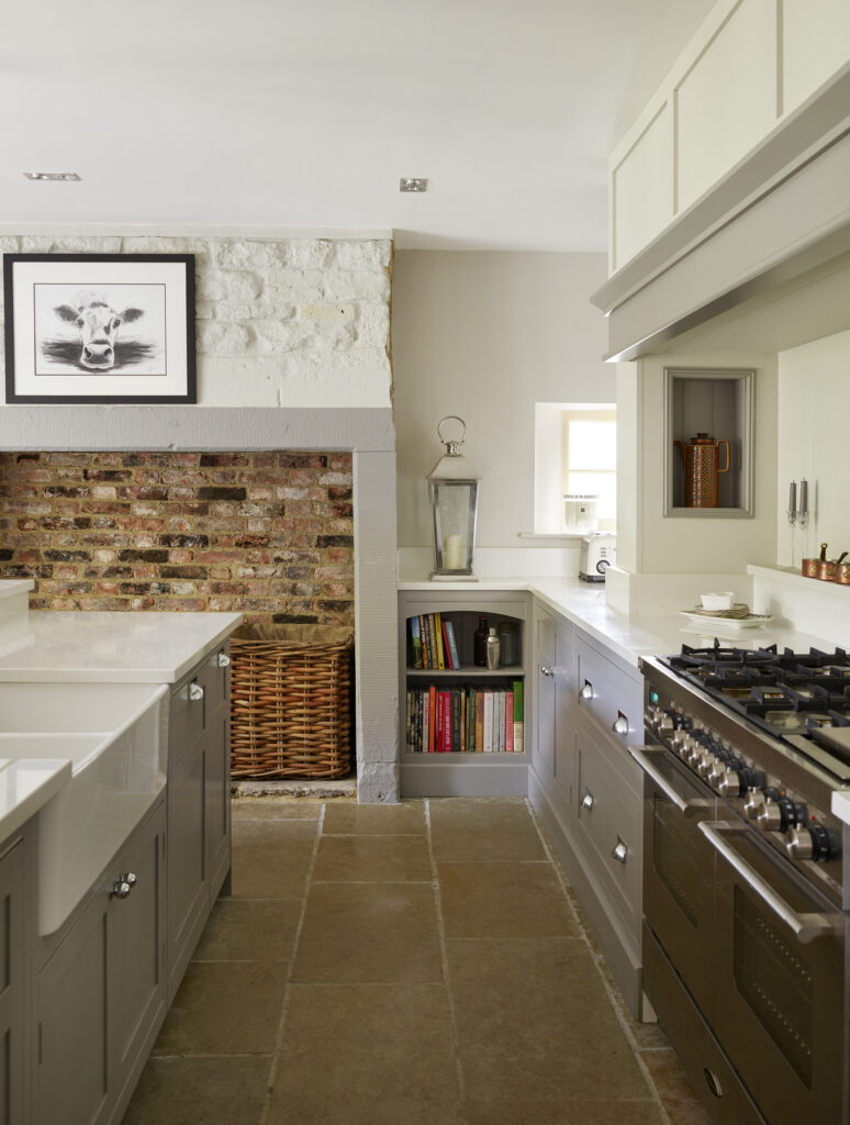 Luxury farmhouse kitchen with fireplace, range cooker and island
