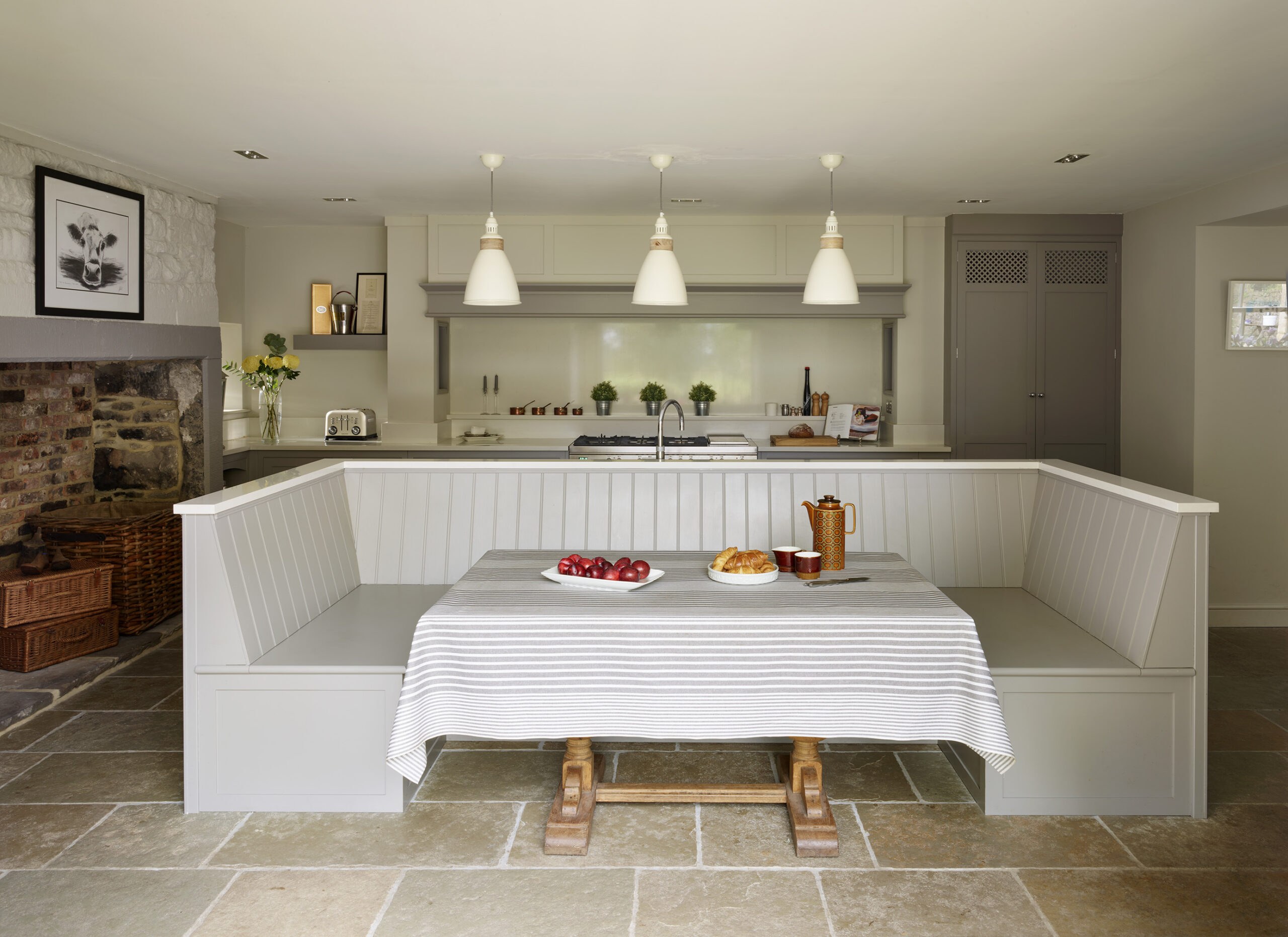 U shaped kitchen bench seating attached to kitchen island in a farmhouse barn conversion