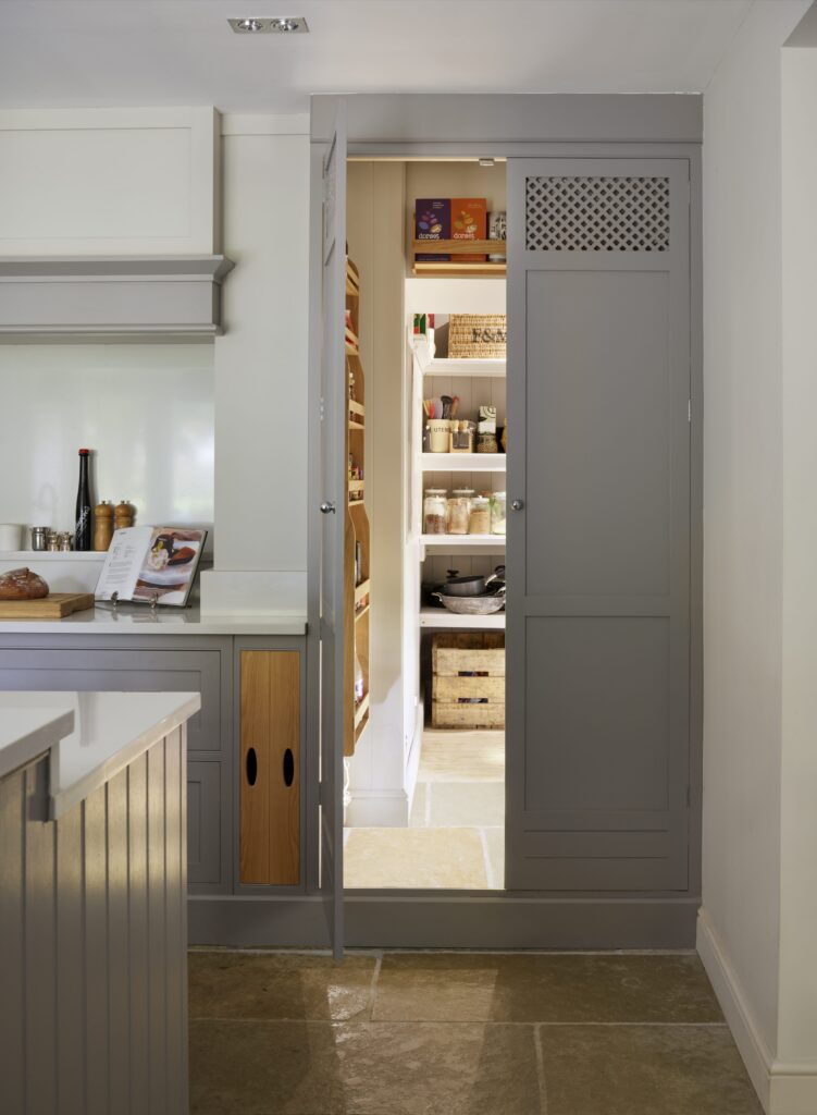 Bespoke hidden kitchen pantry leading on from farmhouse kitchen design