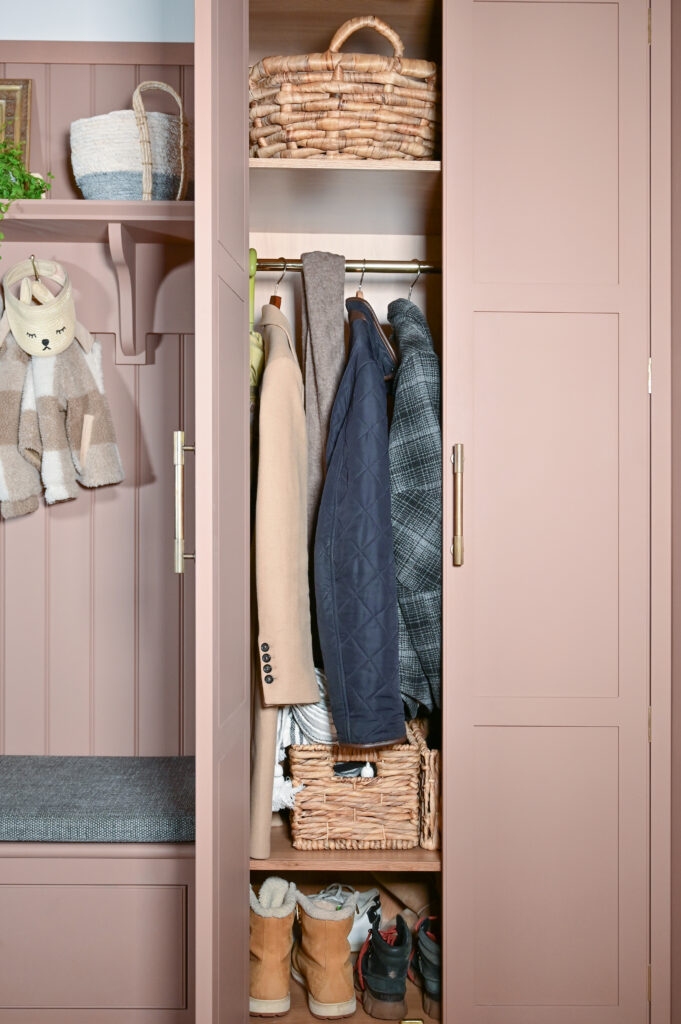 Dusky pink bespoke boot room with hidden storage and bench seating