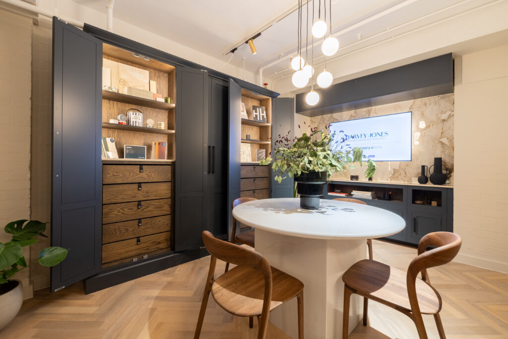 Harvey Jones Heal's kitchen showroom with large built in cupboard display and media wall